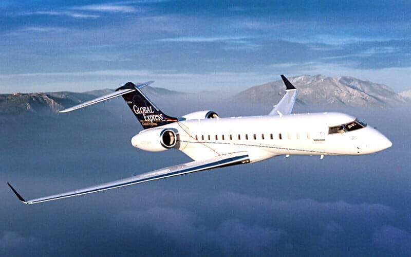Bombardier Global Express XRS flying above mountains